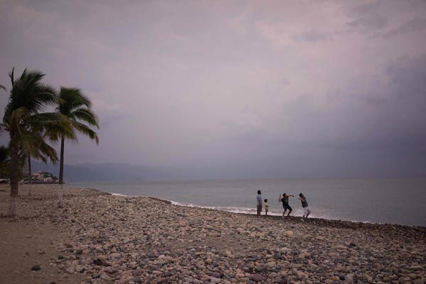 People throw stones into the ocean as hurricane Patricia nears in the Pacific resort city of Puerto Vallarta, Mexico, Thursday, Oct. 22, 2015. <span class=meta>AP Photo/ Cesar Rodriguez</span>
