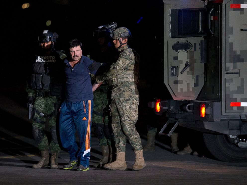 PHOTO: Mexican drug lord Joaquin El Chapo Guzman is escorted by soldiers and marines to a waiting helicopter, at a federal hangar in Mexico City, Jan. 8, 2016. 