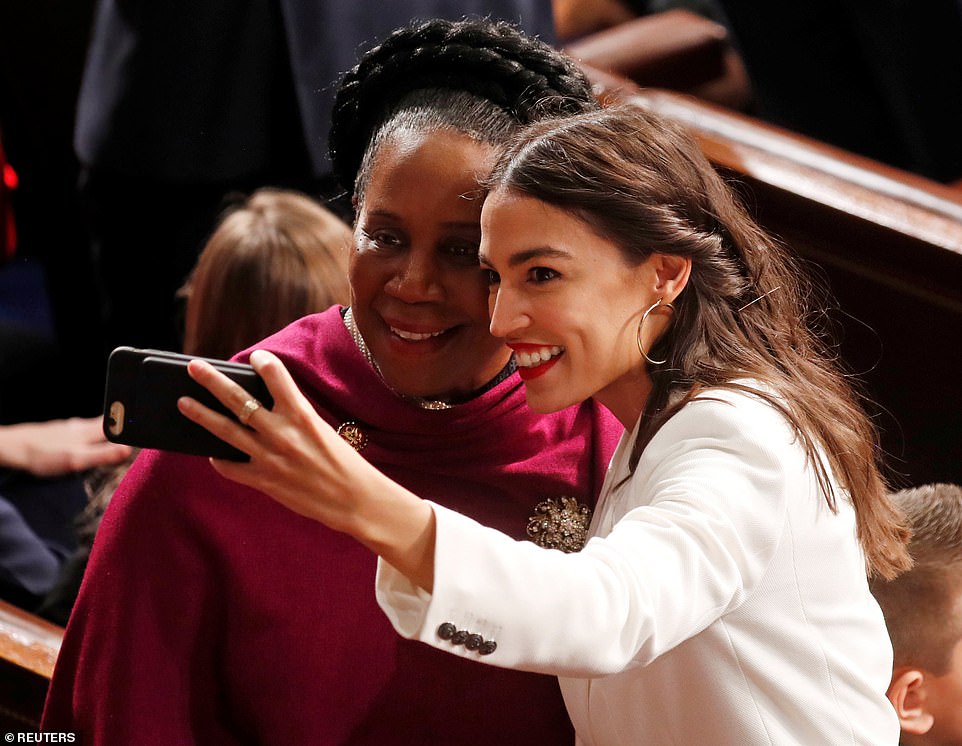 My turn: Alexandria Ocasio-Cortez used an iPhone with extra battery power as she and Sheila Jackson Lee posed together