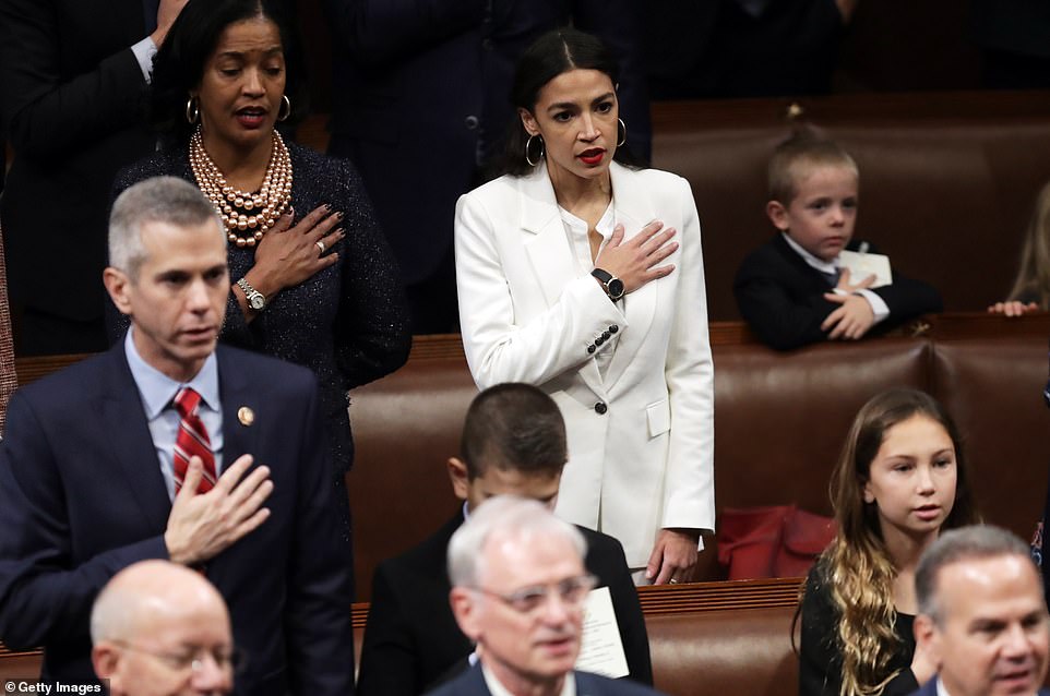 Taking the oath: Alexandra Ocaiso-Cortez stood with Jahana Hayes on one side and an empty seat on the other as members of Congress pledged allegiance