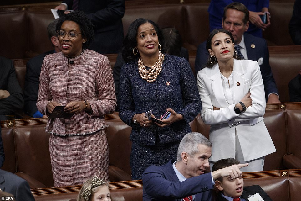 On their feet: Lauren Underwood, Jahana Hayes and Alexandria Ocasio-Cortez in the chamber as Nancy Pelosi waits to become speaker