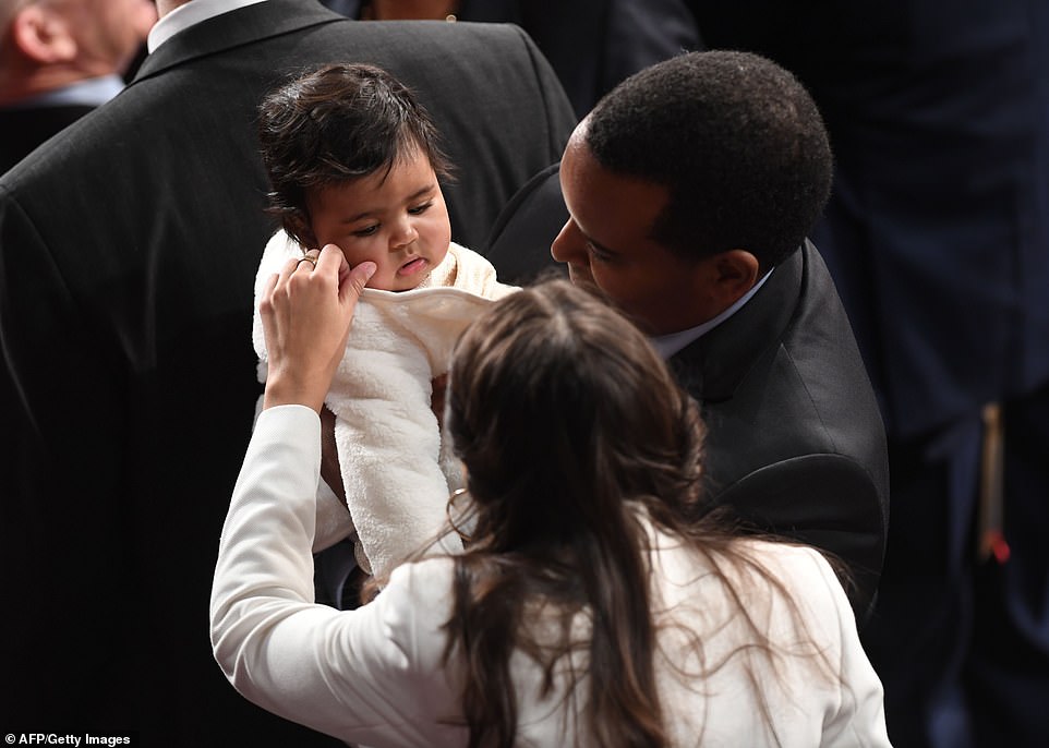 Say hi: Alexandra Ocasio-Cortez greets a baby on the floor of the House of Representatives. Families are welcomed during the opening session