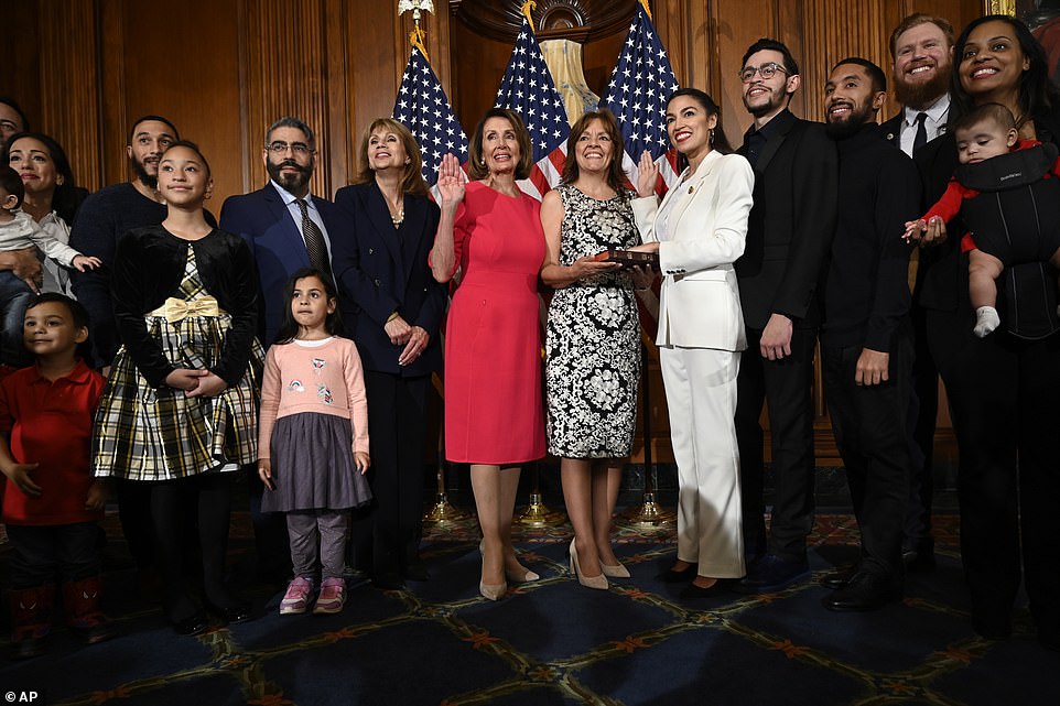 Meet the family: Alexandria Ocasio-Cortez brought members of her family for the ceremony including her boyfriend Riley Roberts, a web developer (second right), her brother Gabriel (fourth from right) and her mom Blanca, who held the Bible or her 